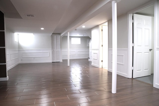 basement with dark hardwood / wood-style floors