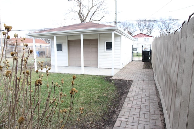 view of outbuilding featuring a garage and a yard