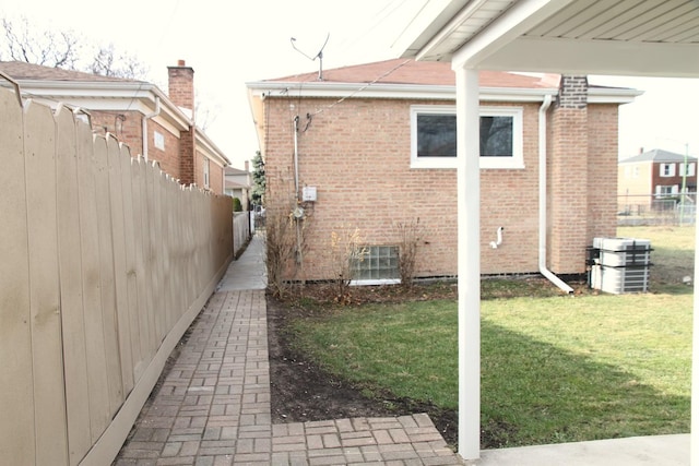 view of side of property with a yard