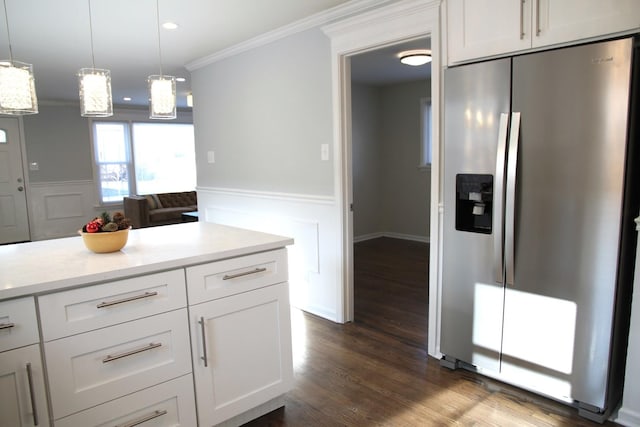 kitchen featuring white cabinetry, crown molding, stainless steel fridge with ice dispenser, and hanging light fixtures