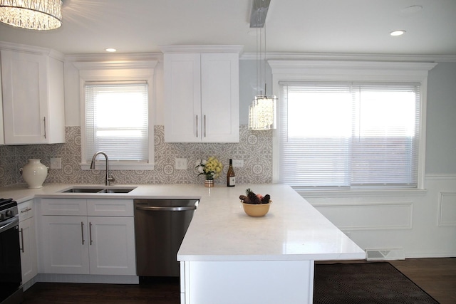 kitchen featuring sink, white cabinetry, decorative light fixtures, dishwasher, and kitchen peninsula