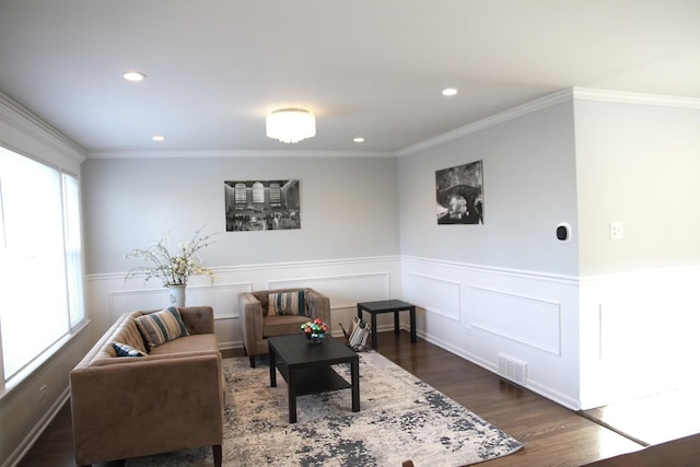 living room with crown molding and dark hardwood / wood-style flooring