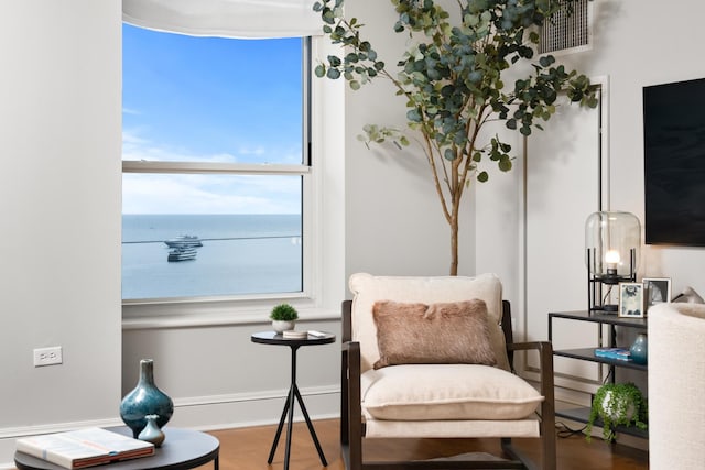 sitting room featuring baseboards, visible vents, and wood finished floors