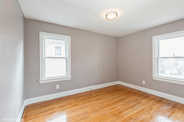 empty room featuring light hardwood / wood-style flooring and a healthy amount of sunlight