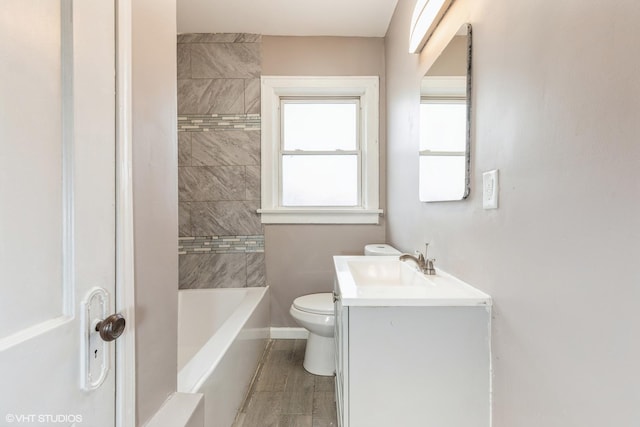 full bathroom featuring vanity, toilet, and tiled shower / bath combo