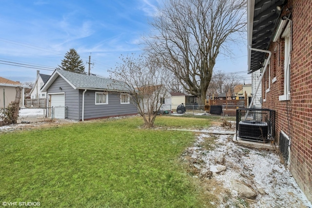 view of yard with an outbuilding, a garage, and central AC unit