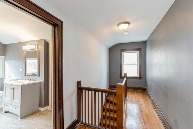 corridor featuring light hardwood / wood-style floors and sink