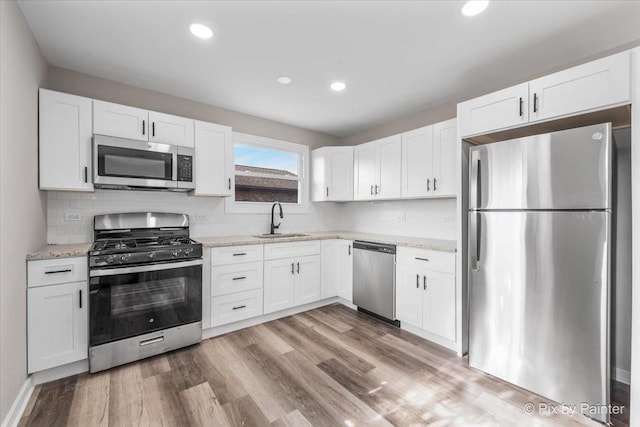 kitchen with white cabinetry, sink, and appliances with stainless steel finishes