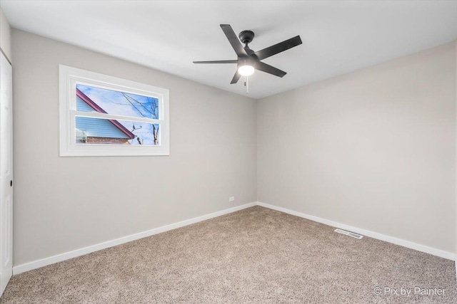 empty room with ceiling fan and carpet flooring