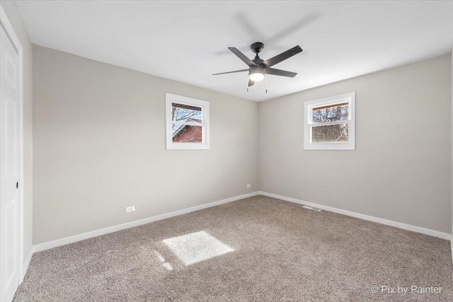 unfurnished room with ceiling fan and carpet floors