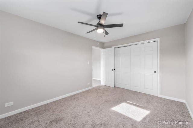 unfurnished bedroom featuring carpet flooring, ceiling fan, and a closet