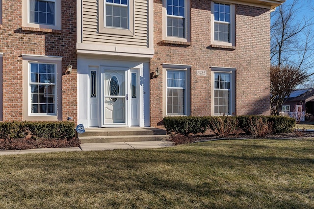 property entrance with a yard