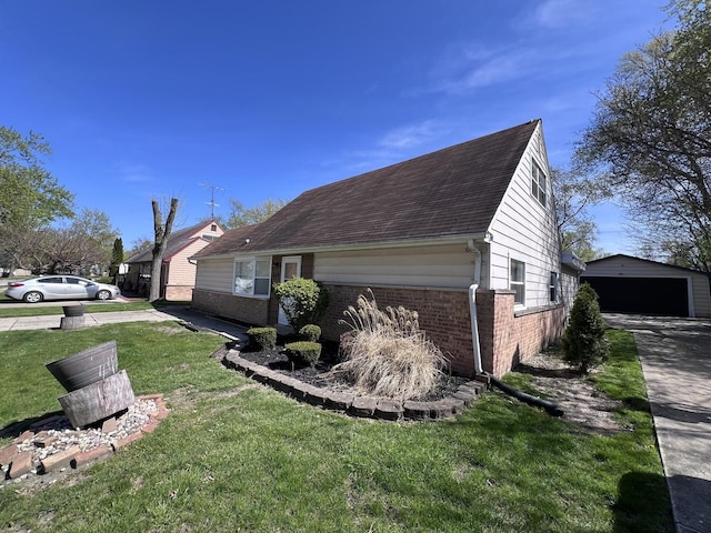 view of property exterior featuring an outbuilding, a garage, and a lawn