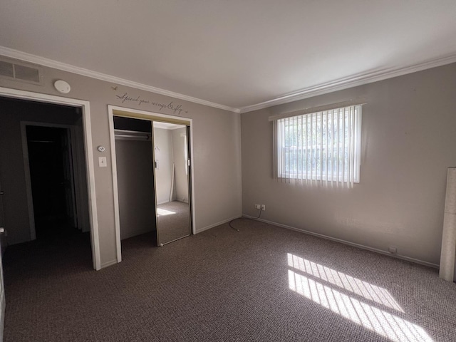 unfurnished bedroom with crown molding, a closet, and carpet