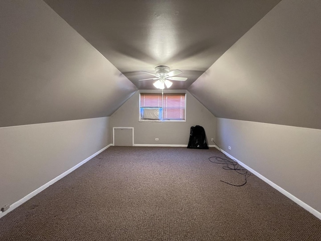 additional living space with vaulted ceiling, carpet floors, and ceiling fan