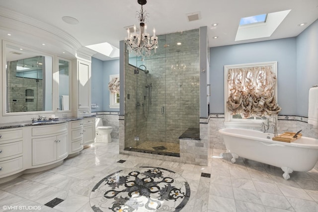 full bathroom featuring tile walls, a skylight, vanity, shower with separate bathtub, and toilet