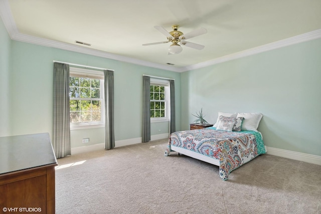 carpeted bedroom featuring ornamental molding and ceiling fan