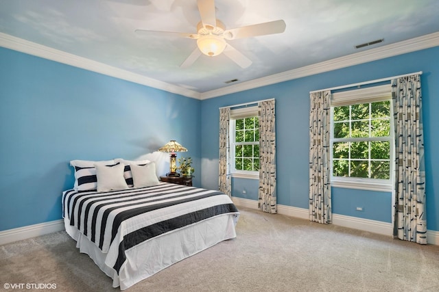 bedroom featuring multiple windows, carpet floors, ornamental molding, and ceiling fan