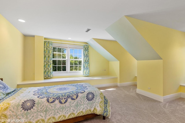 bedroom featuring vaulted ceiling and light carpet