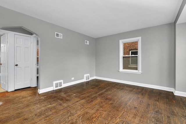 empty room featuring dark hardwood / wood-style flooring