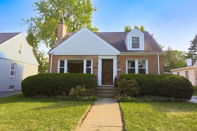 cape cod home with a front lawn