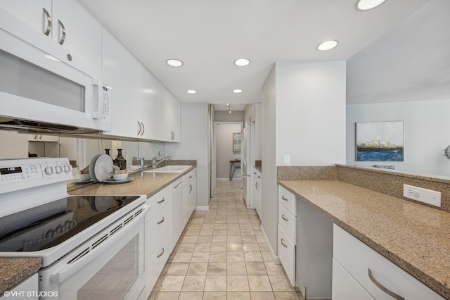 kitchen featuring light stone counters, white appliances, sink, and white cabinets