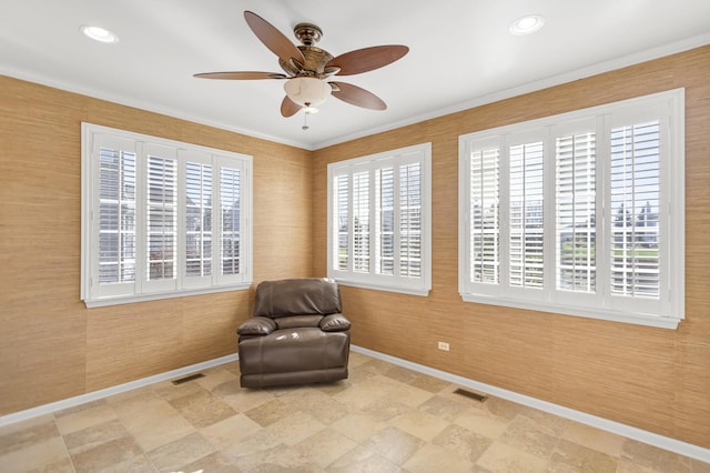 living area featuring crown molding, ceiling fan, and a healthy amount of sunlight