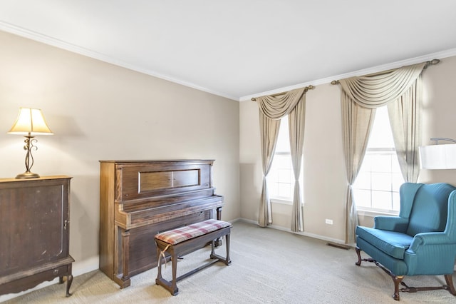 living area featuring ornamental molding, a healthy amount of sunlight, and light colored carpet