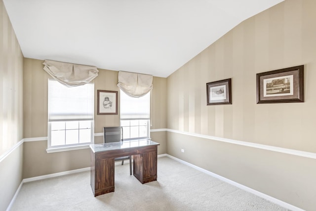 carpeted home office featuring lofted ceiling