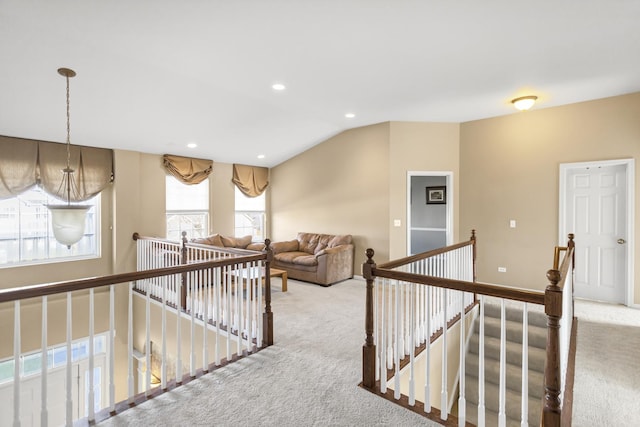 hallway featuring carpet floors and vaulted ceiling