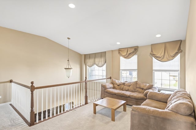 carpeted living room with vaulted ceiling and a wealth of natural light