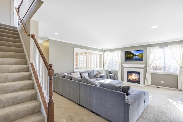 living room with ornamental molding, a healthy amount of sunlight, and light carpet