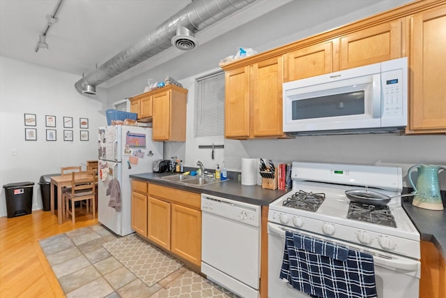 kitchen with sink, white appliances, rail lighting, and light wood-type flooring