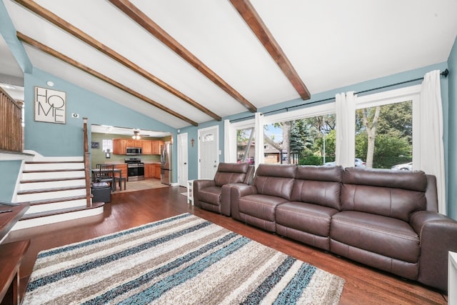 living room with a healthy amount of sunlight, dark hardwood / wood-style floors, and vaulted ceiling with beams