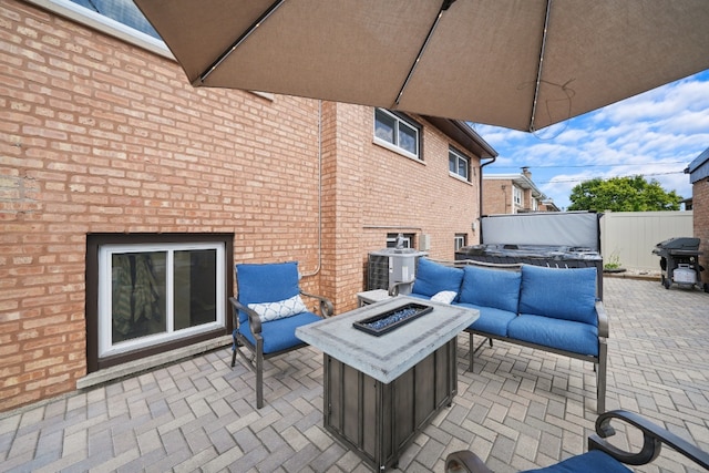 view of patio with cooling unit, a fire pit, and area for grilling