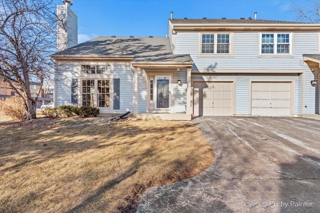 view of front property with a garage and a front lawn