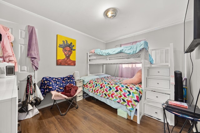 bedroom featuring crown molding and dark hardwood / wood-style floors