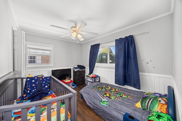 bedroom featuring ceiling fan, ornamental molding, and dark hardwood / wood-style flooring