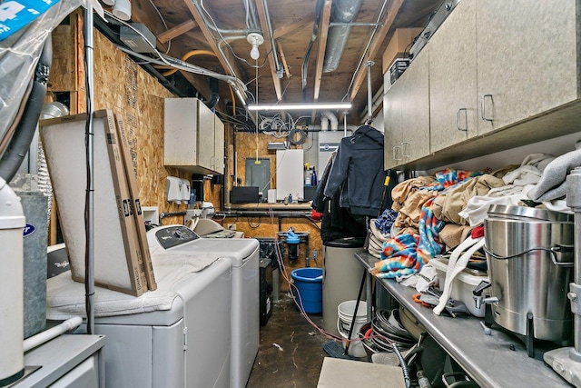 clothes washing area featuring separate washer and dryer and cabinets