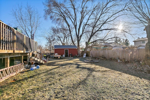 view of yard with a storage shed and a deck