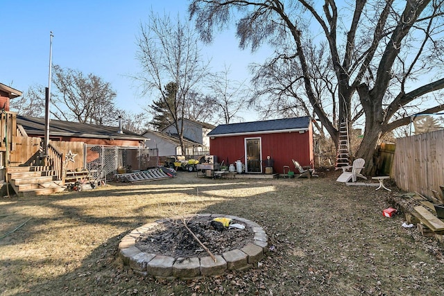 view of yard featuring a fire pit and an outdoor structure