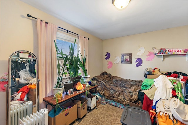 carpeted bedroom with radiator heating unit