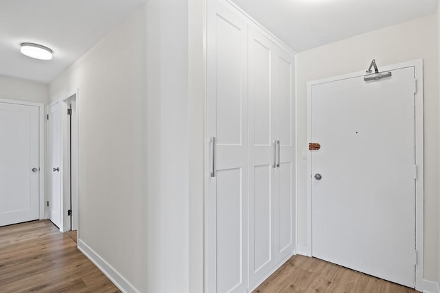 hall with light hardwood / wood-style flooring