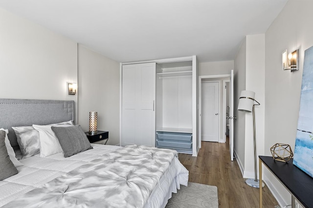 bedroom with hardwood / wood-style floors and a closet