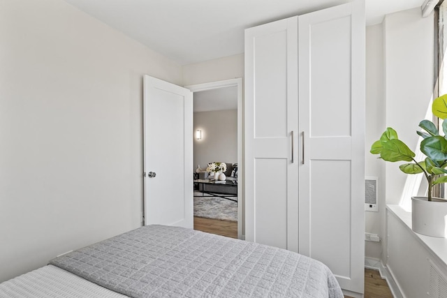 bedroom with hardwood / wood-style floors