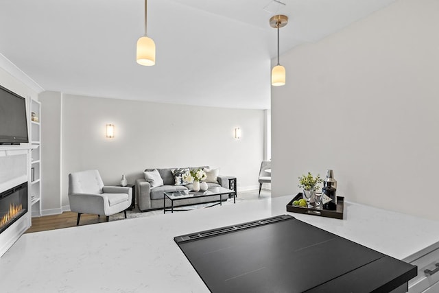 living room featuring built in shelves and hardwood / wood-style flooring