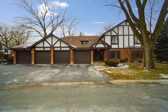 tudor-style house featuring a garage