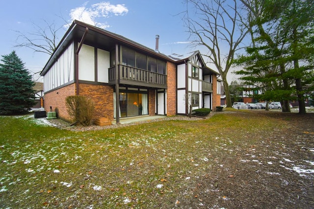 back of house featuring central AC and a lawn