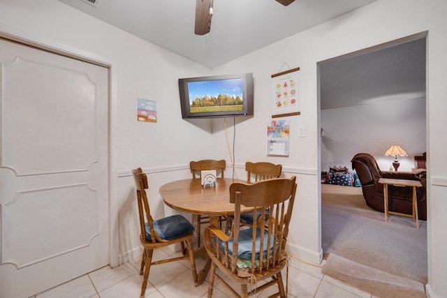 tiled dining area with ceiling fan