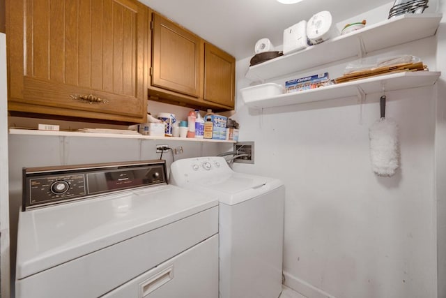 laundry area with cabinets and washing machine and dryer